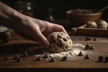 Photo Of Baker's Hand Holding A Raw Chocolate Ball