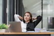 © Songsak C - Young Asian businesswoman relaxing at workplace in an office.