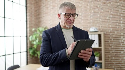 Sticker - Middle age grey-haired man business worker writing on touchpad at office