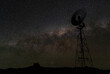 Night sky milky way galaxy with windmill silhouetted