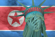 Statue of Liberty. Facepalm emoji on background in colors of Korea North flag