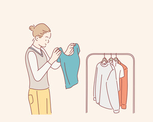 Beautiful young woman near rack with clothes making chioce. Hand drawn style vector design illustrations.