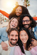 © Jose Calsina - Vertical portrait of a group of friends laughing together and looking at camera. Five young multiracial people smiling and having fun. Joyful startup team coworkers celebrating and bonding together