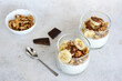 © Irina - A healthy snack with chocolate, bananas, chia seeds and walnut with a spoon next to it