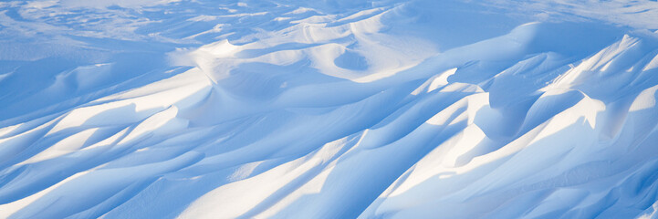 Wall Mural - snow texture. wind sculpted patterns on snow surface. wind in the tundra and in the mountains on the