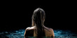 © Tatiana - A young beautiful slender woman is standing in the water of the pool, a view from the back and a close-up. Generative AI