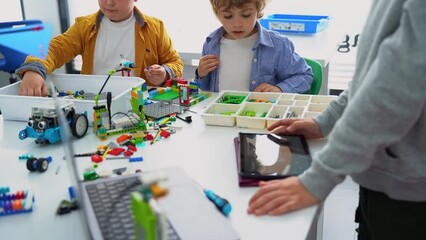Wall Mural - robotics programming class. children construct and code robot. stem education using constructor bloc