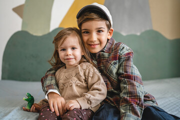 Wall Mural - siblings portrait caucasian boy and girl brother and sister at home