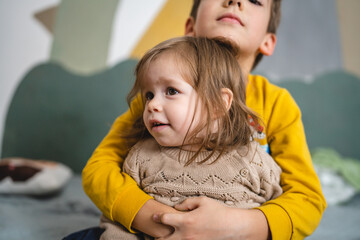 Wall Mural - siblings portrait caucasian boy and girl brother and sister at home