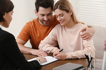 Wall Mural - Professional notary helping couple with paperwork in office