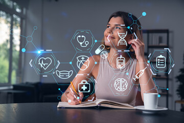 Smiling woman in casual wear taking notes in notebook at office workplace with coffee cup. Concept distant business education, information technology, dreaming, thinking. Health care medical drawings
