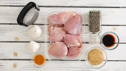 Wall Mural - Marinating raw chicken meat with soy sauce, black pepper, turmeric, seasoning, and fresh garlic can be an excellent way to bring out the best flavor in the chicken