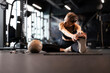 © ty - Young sporty woman stretching at the gym.