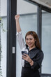 © David - Young happy excited asian woman, professional entrepreneur work in office clothing, smiling and looking confident, workplace background
