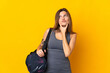 © luismolinero - Slovak sport woman with sport bag isolated on yellow background having doubts