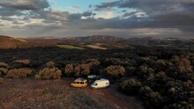 4K Drone Footage At Sunset Over People And Camper Vans In Beautiful Forest Spot With Huge Panoramic Landscape On The Back, Ager, Catalonia, Spain.
Mid Angle, Parallax Movement.
