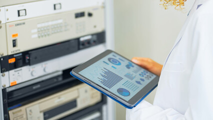 Aufkleber - Engineer holding a tablet and operating an electronic device.