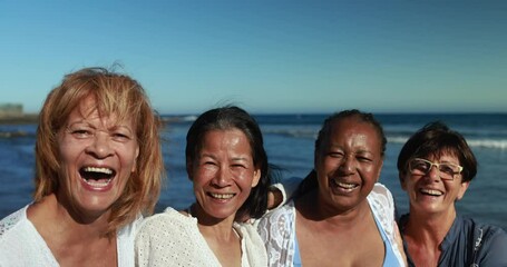 Poster - Happy multiracial senior women having fun together smiling in front of camera on the beach wearing summer clothes - Joyful elderly lifestyle, vacation and travel concept