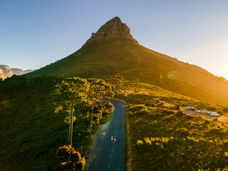 a couple of men and women watching the sunset at lion's head near table mountain cape town south afr