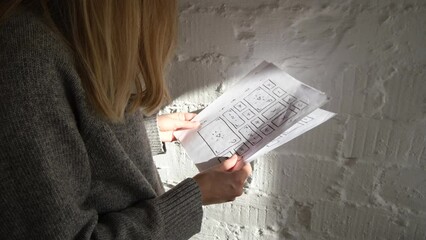 Wall Mural - woman designer looks through website design prototypes and wireframe. ui/ux designer at work. create