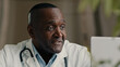 © Yuliia - African doctor psychotherapist middle-aged man general practitioner talking with patient online video call in conference virtual webcam chat app medic consulting remote during corona virus pandemic