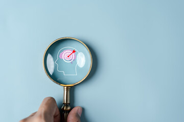 Wall Mural - Magnifying glass focus to human brain and target objective icon inside for plan, thinking business strategy development leadership and customer target group concept.