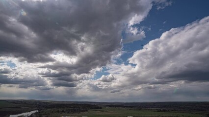 Wall Mural - dark beautiful clouds, dramatic sky over a beautiful valley. the clouds are moving forward. 4k timel
