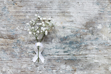 Canvas Print - White flowers with white ribbon on old wooden background. Flat lay. Wedding, birthday still life scene. Blank greeting card mockup.