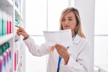 Sticker - Young blonde woman pharmacist reading prescription at pharmacy