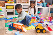 © Krakenimages.com - Adorable boy and girl playing with construction blocks and car toy at kindergarten