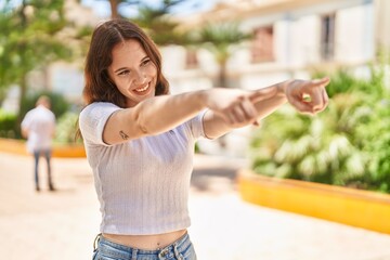 Sticker - Young woman smiling confident pointing with fingers at park