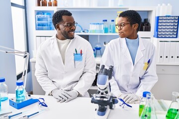 Canvas Print - Man and woman scientists smiling confident at laboratory