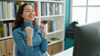 © Krakenimages.com - Young beautiful hispanic woman student using computer with winner expression at university classroom