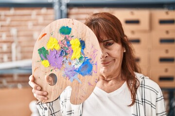 Canvas Print - Middle age hispanic woman holding palette covering face skeptic and nervous, frowning upset because of problem. negative person.