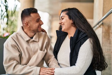 Poster - Man and woman couple sitting on stairs together at street