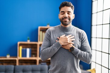 Poster - Young hispanic man smiling confident with hands on chest at home