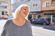 © Krakenimages.com - Middle age blonde woman smiling confident standing at street