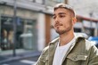 © Krakenimages.com - Young hispanic man smiling confident standing at street