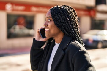 Poster - African american woman smiling confident talking on the smartphone at street