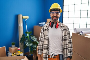 Wall Mural - Young hispanic man with beard working at home renovation with a happy and cool smile on face. lucky person.