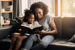 © okhaly - Black mother reads a book to her little daughter while sitting together on a sofa made with Generative AI technology