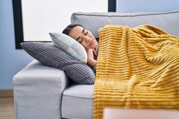 Wall Mural - Young hispanic woman lying on sofa sleeping at home