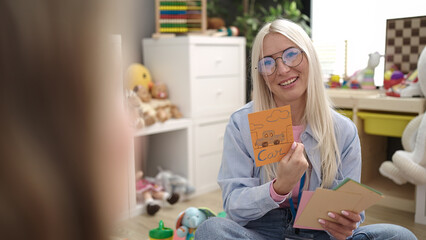 Sticker - Young blonde woman preschool teacher having vocabulary lesson at kindergarten