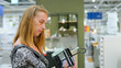 © Viktoriya Agarkova - Woman choosing kitchen accessories in the department of dishware.