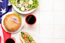 Composition With Tasty Burger, Hot Dog, Salad, Cola And American Flag On Light Tile Background. American Day Celebration