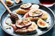 Tasty bruschetta with cream cheese, proscuitto  and figs for breakfast time