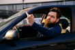 © phoenix021 - Man expressing negative emotions from the car flipping middle finger to other driver, road rage
