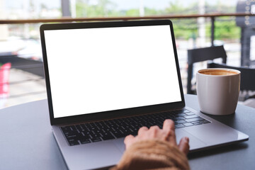 Wall Mural - mockup image of a woman using and working on laptop computer with blank white desktop screen