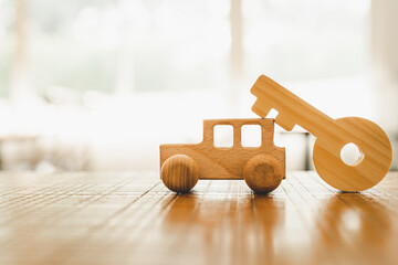 Wall Mural - Wooden car and key model with sunlight, a symbol for buying a new car, vehicle car auto repair service maintenance.	