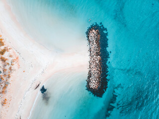 Wall Mural - Aerial view of beautiful tropical turquoise ocean sea waters with shallow waves on the breakwater. Vibrant bright sunny day in summer wallpaper. Seascape background. Coastal wallpaper.